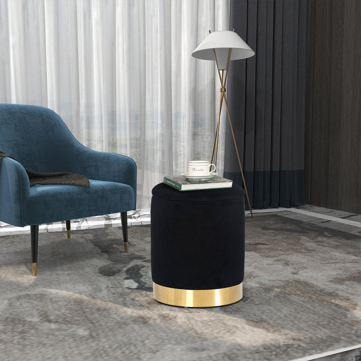 Round velvet storage ottoman with gold base, padded footrest.